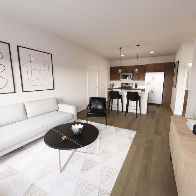 Bright living room and kitchen view of a Solhaven one-bedroom apartment.
