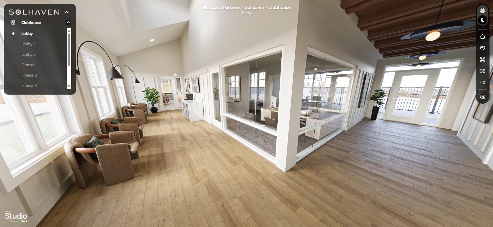 The Commons clubhouse at Solhaven Grand Chute with seating, natural light, and views into the leasing office.
