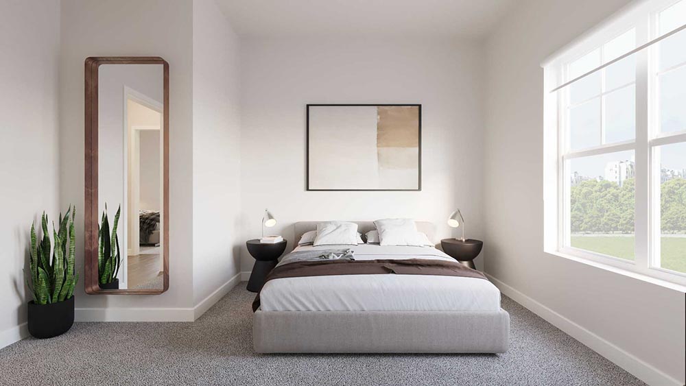 Secondary bedroom with tall mirror, plant, and bright window.