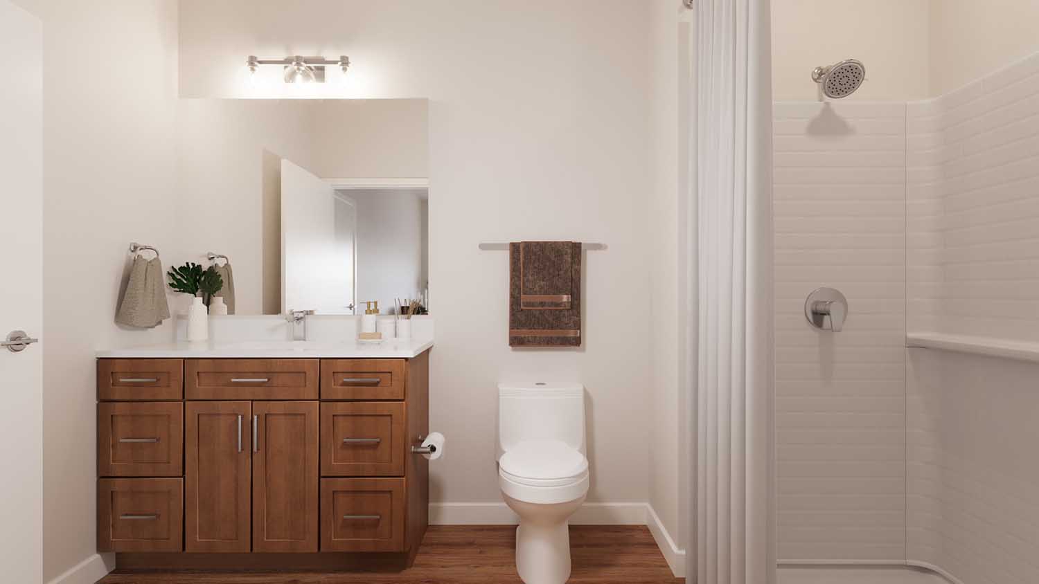 Bathroom with quartz-style counters, wood vanity, and tiled shower.